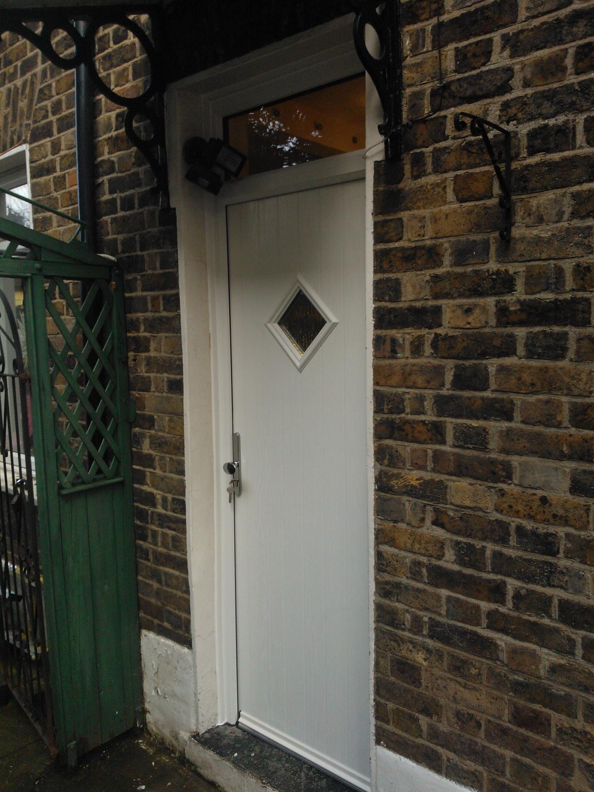 The Solidor Flint 1 composite door brings rustic charm with its vertical plank design and classic single diamond window