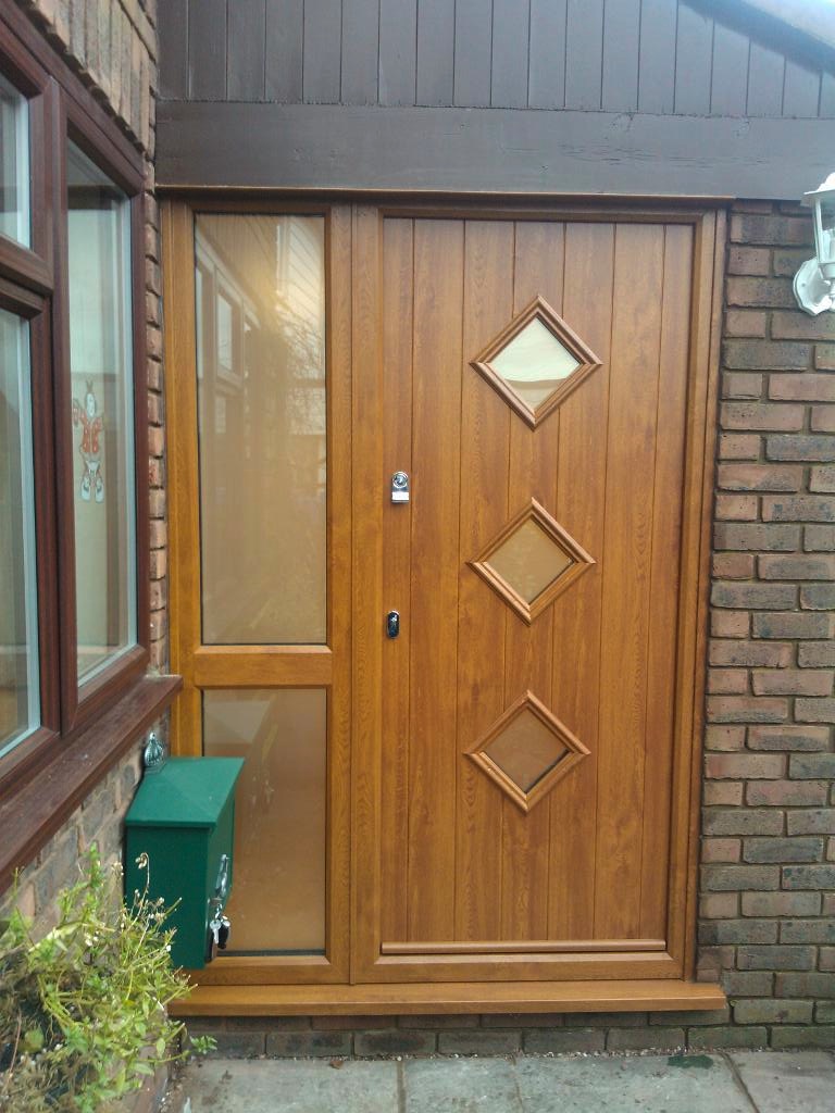 The Solidor Flint 3 composite door combines a rustic vertical plank style with three evenly spaced, diamond-shaped glass panels for a beautifully balanced cottage look