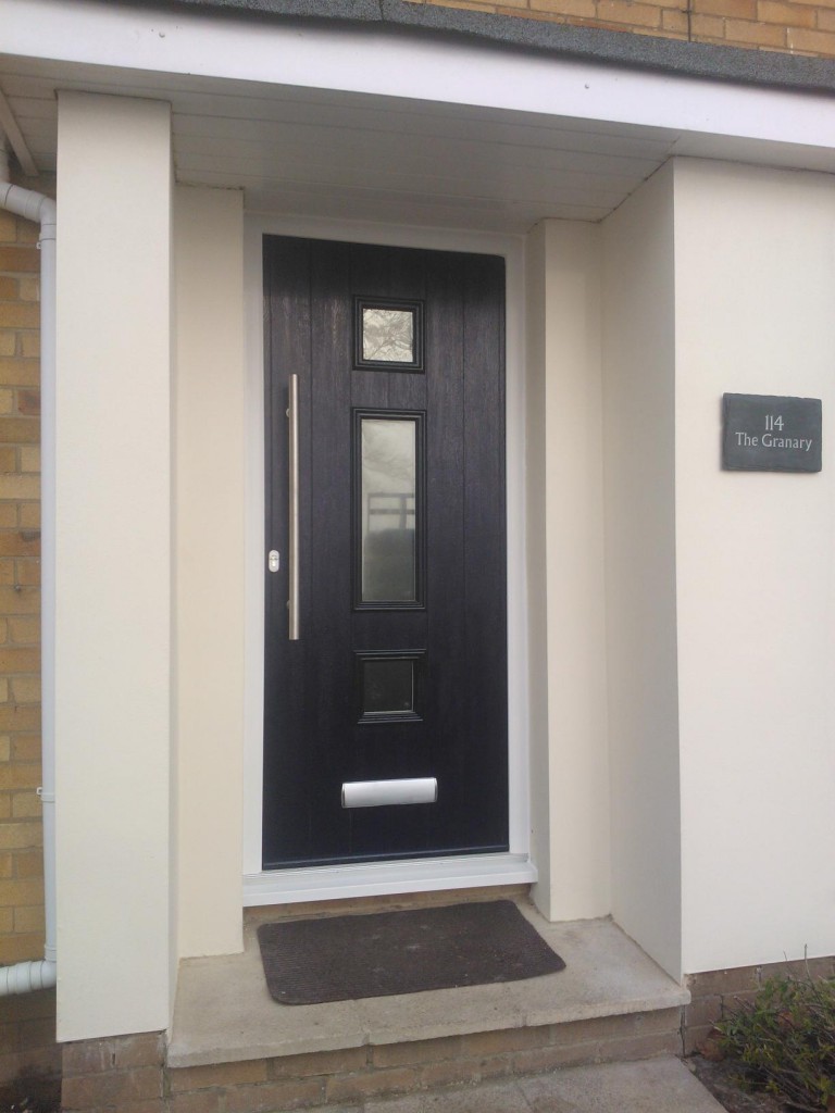 Solidor Genoa composite door in Schwarzbraun with modern black hardware for a luxury-look entrance.
