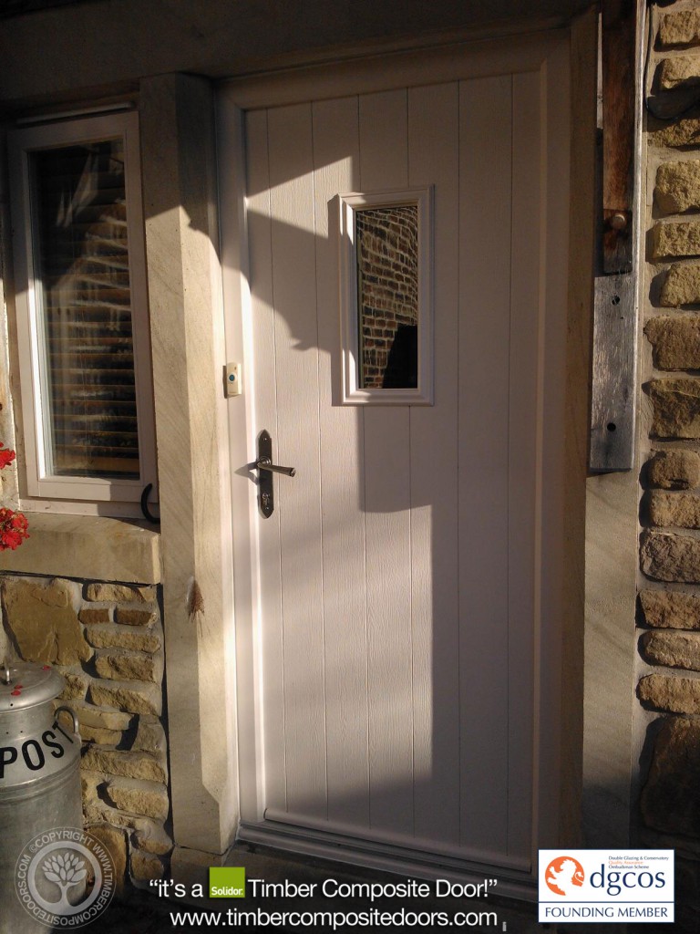 The Solidor Flint 2 composite door pairs a rustic, cottage-style vertical plank design with twin vertical glazing cassettes for an elegant, light-filled entrance
