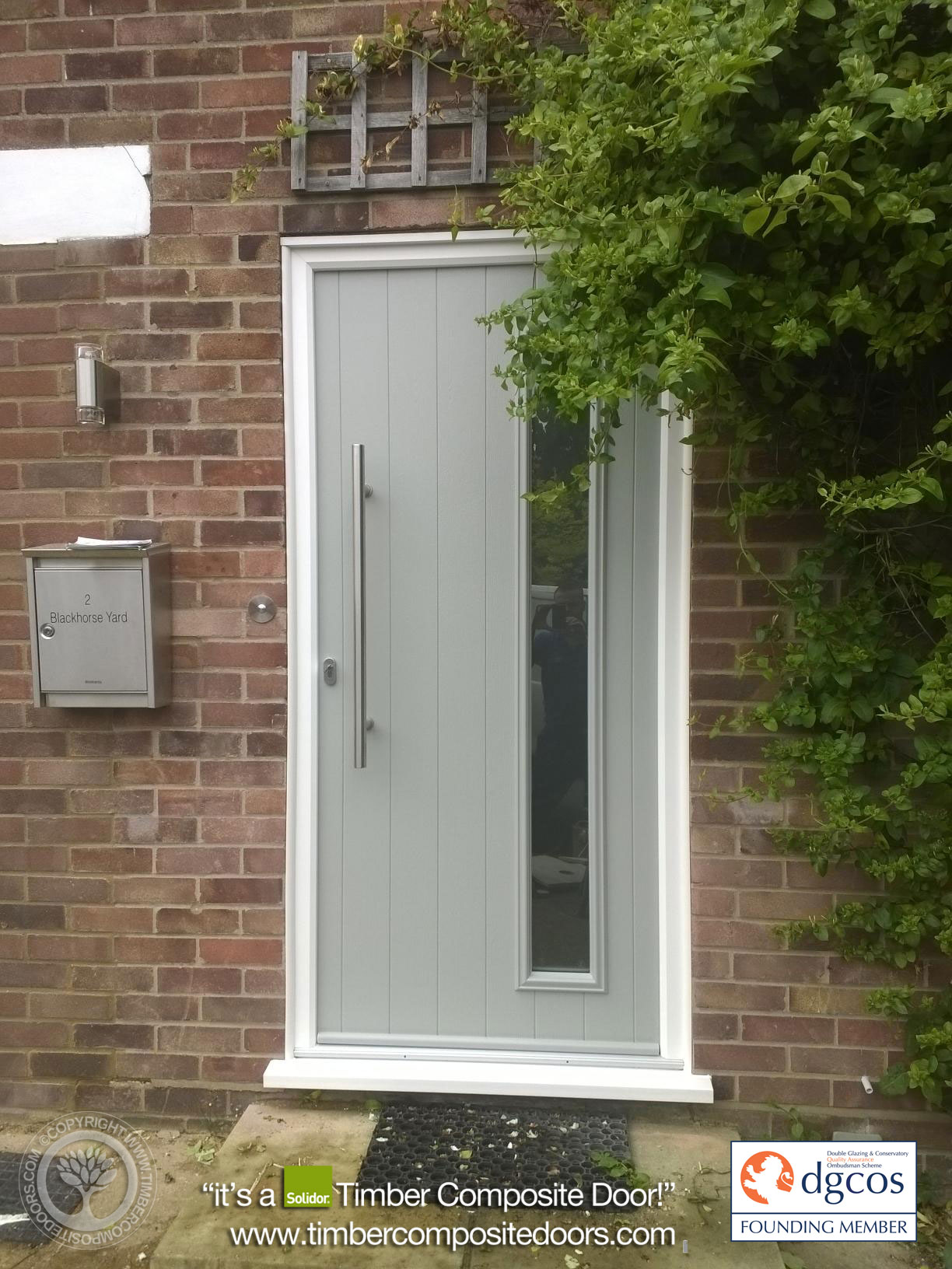 Modern Solidor Brescia composite door from the Italia Collection featuring contemporary glazing and a long bar handle for a premium architectural entrance
