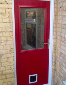 an image of a solidor composite door with a cat flap fitted